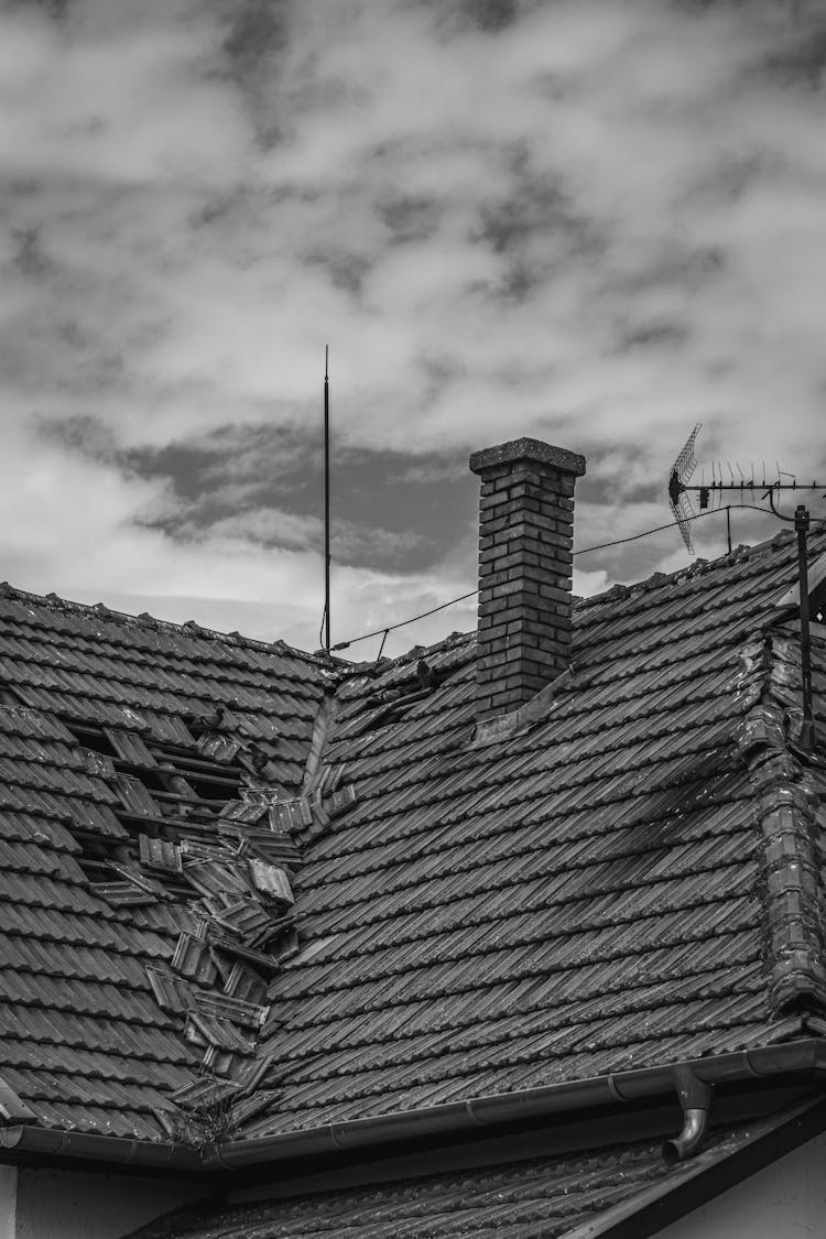 Grayscale Photo Of A Broken Roof Tiles 