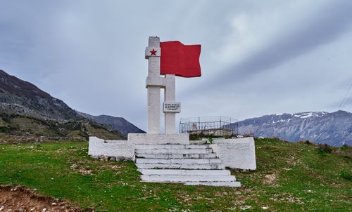 Free Explore the striking communist monument in rural Vlorë, Albania, featuring a red star and flag. Stock Photo