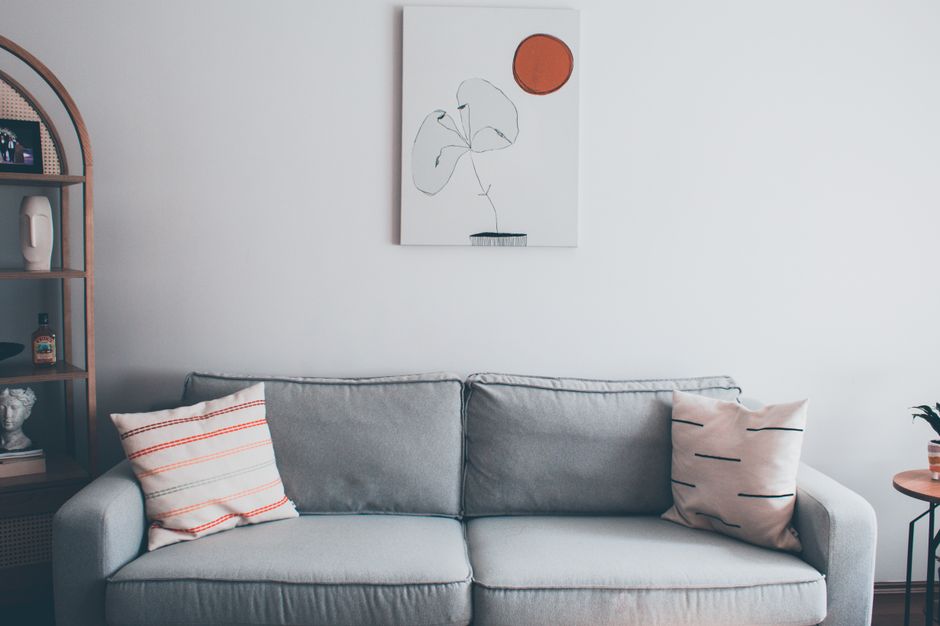 Elegant living room featuring a modern gray sofa and abstract wall art in Istanbul.