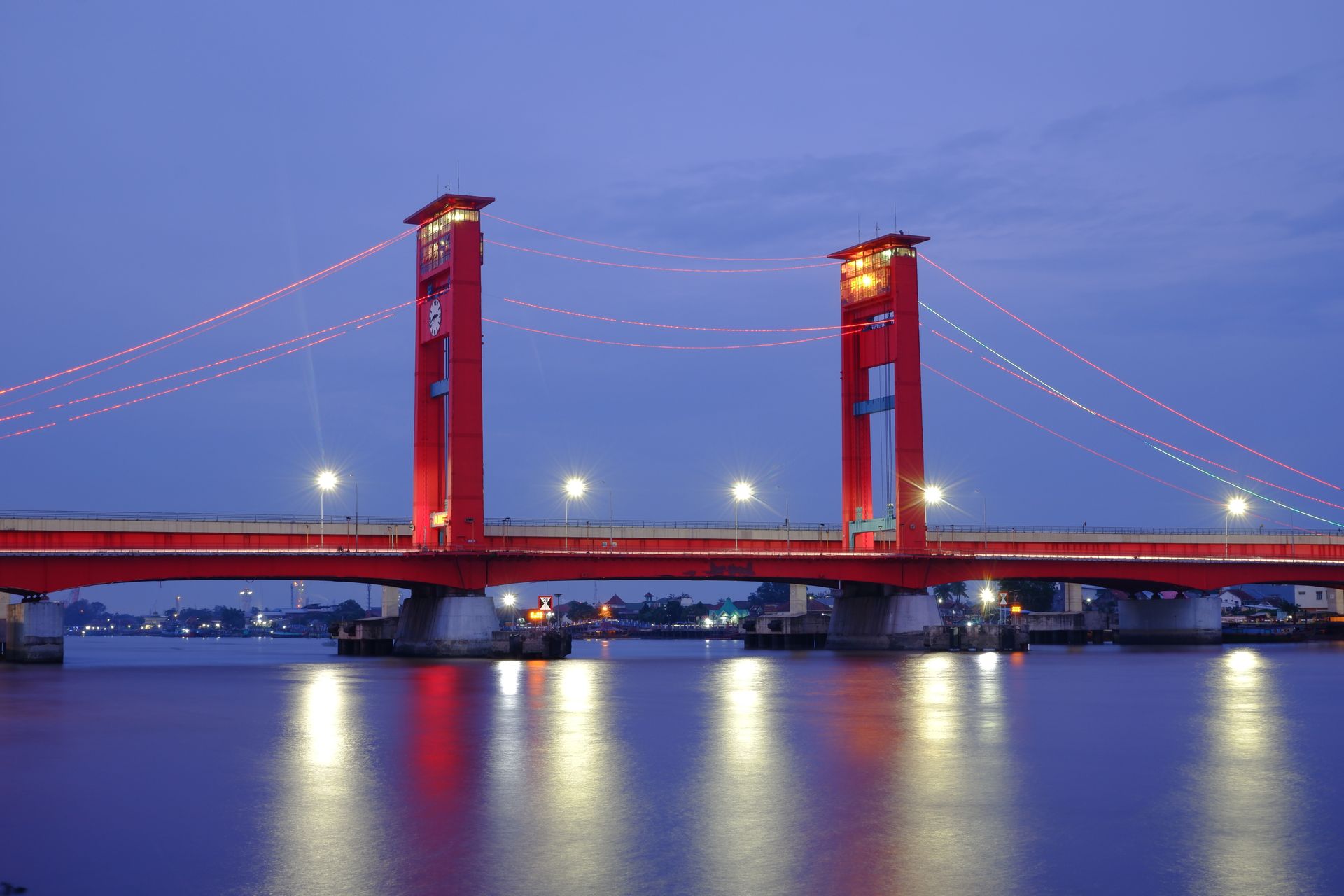 Stunning night view of Ampera Bridge in Palembang, Indonesia with beautifully reflected lights.