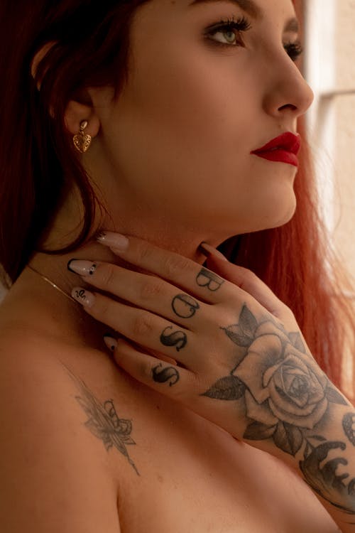 Close Up Photo of Woman with Tattoo on Her Hand
