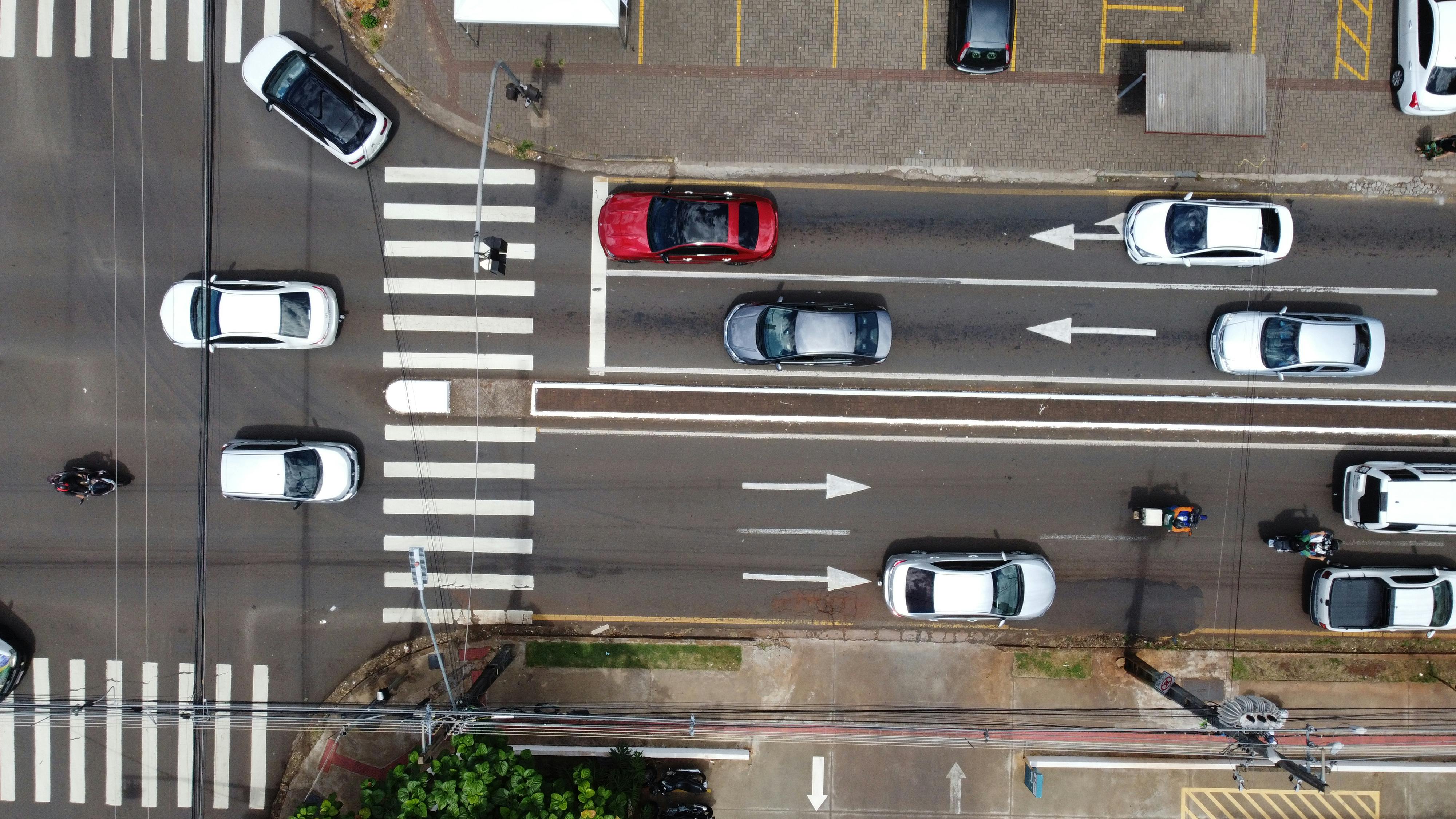 Aerial drone view of vehicles and traffic on a busy street in Londrina, Brazil.