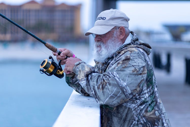 A Bearded Man Holding A Fishing Rod 