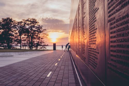 Free Beautiful sunset reflecting on a memorial wall in Tallinn, Estonia. Stock Photo