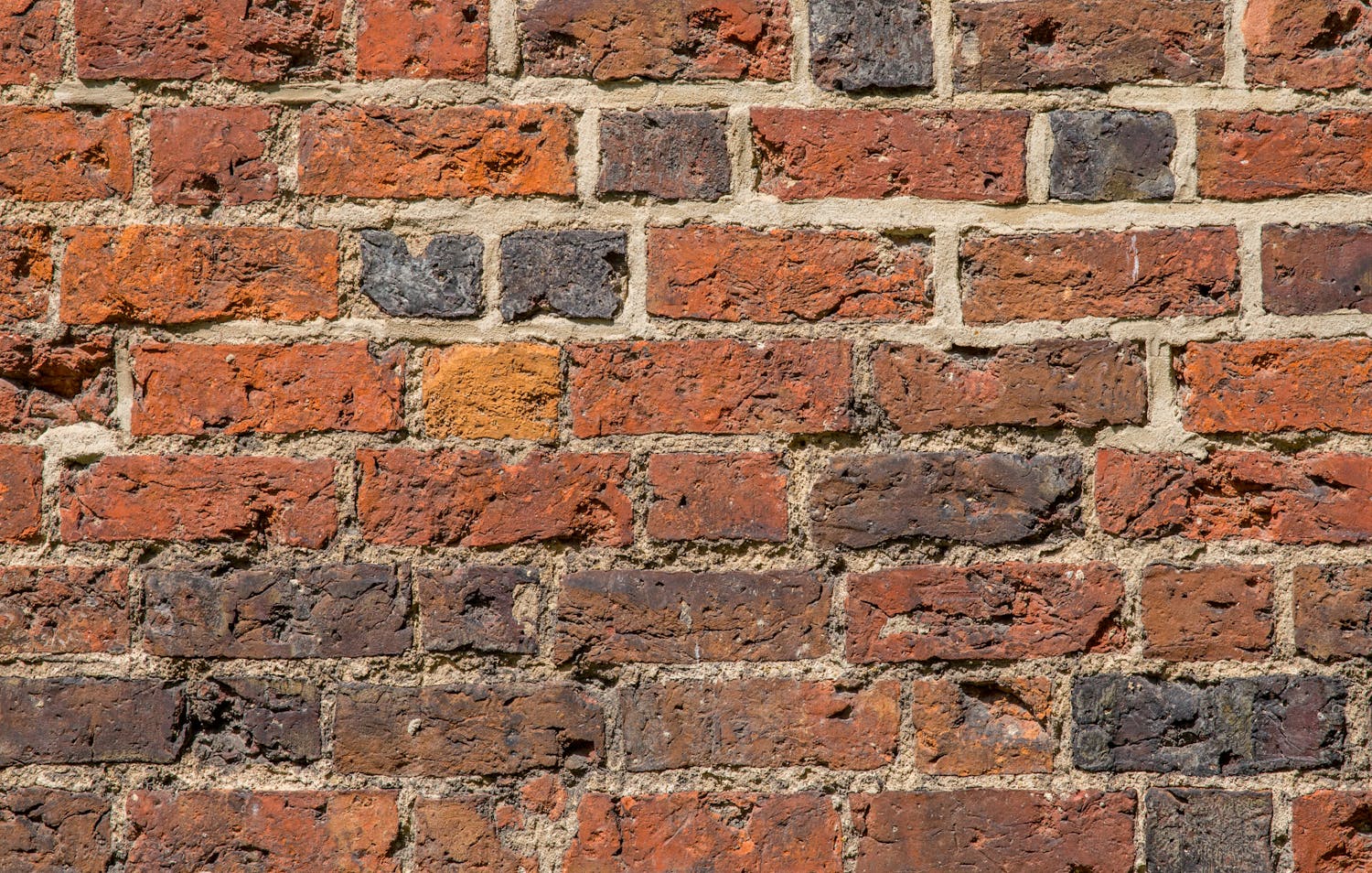 Textured red brick wall