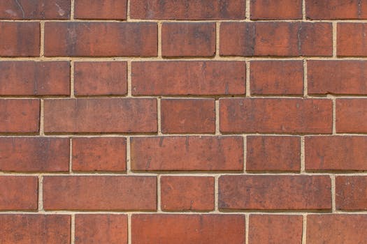Detailed close-up of a red brick wall pattern showing texture and surface details.