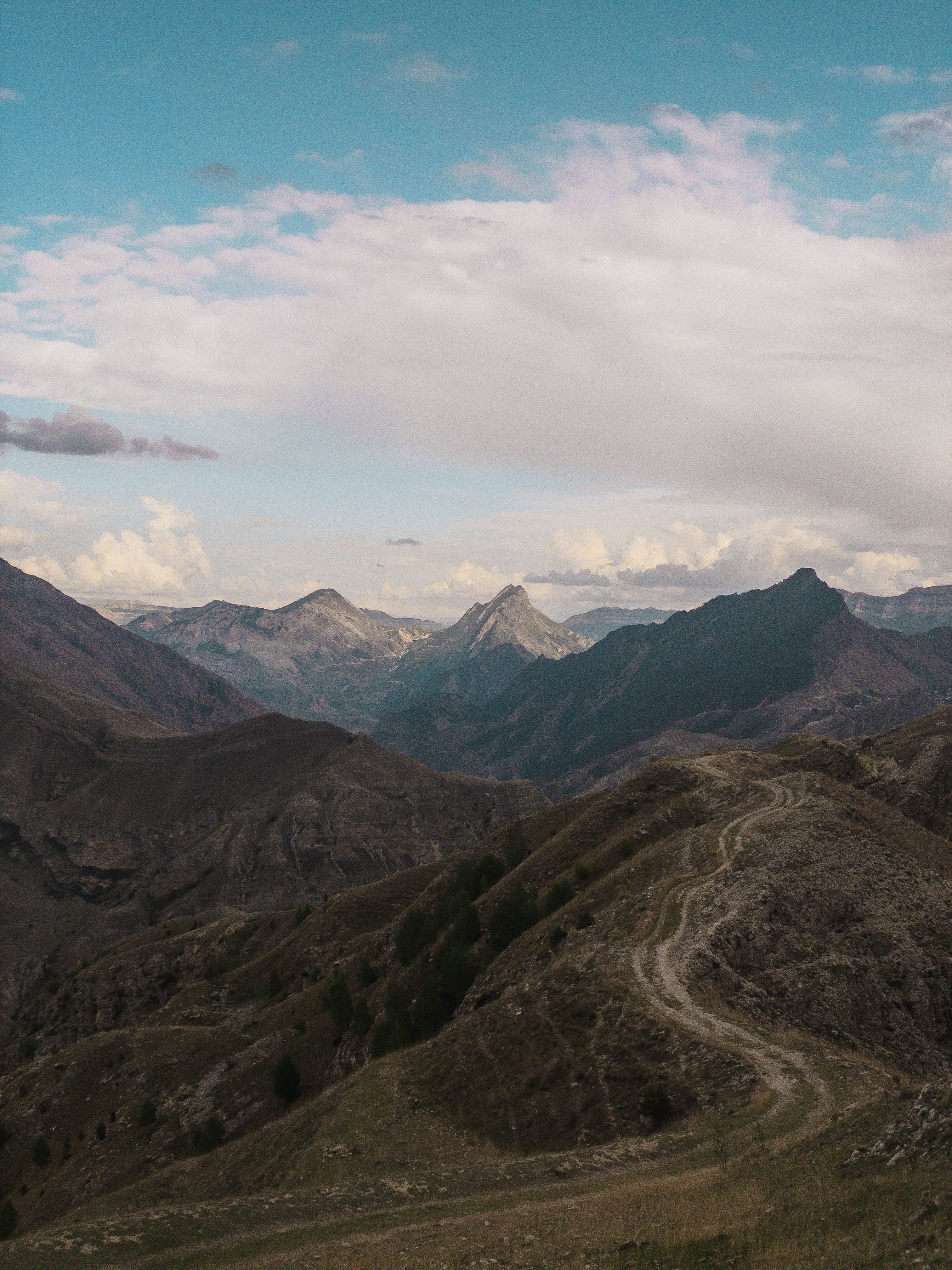 Aerial View of Brown Mountains Under White Clouds · Free Stock Photo