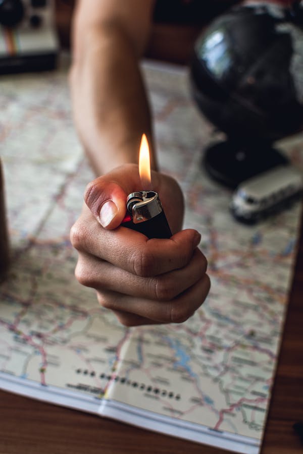 Person Holding Black Disposable Lighter