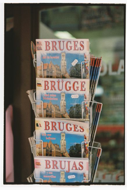 Close-up of a rack displaying Bruges souvenirs in a Belgian shop.