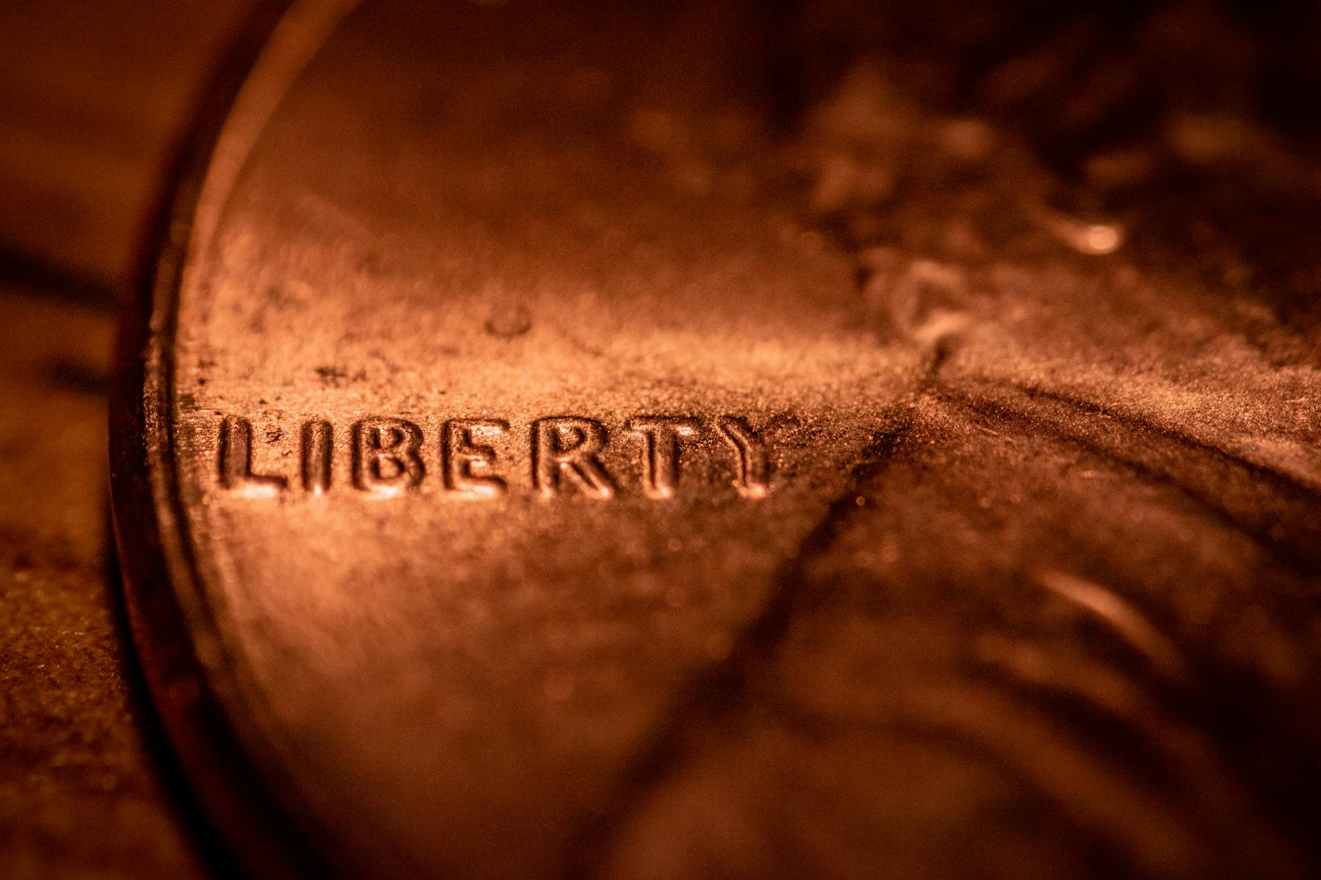 Liberty title with depicted profile of man on coin