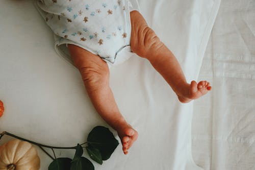 A Baby Lying on a Bed 