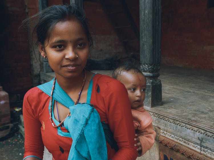 Woman Carrying A Baby On Her Back