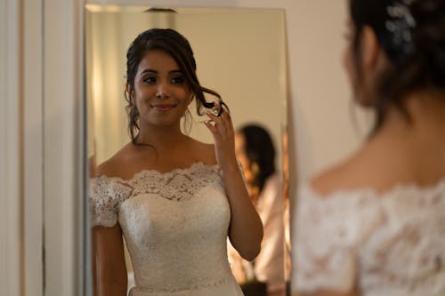 Bride Touching Her Hair in Front of the Mirror