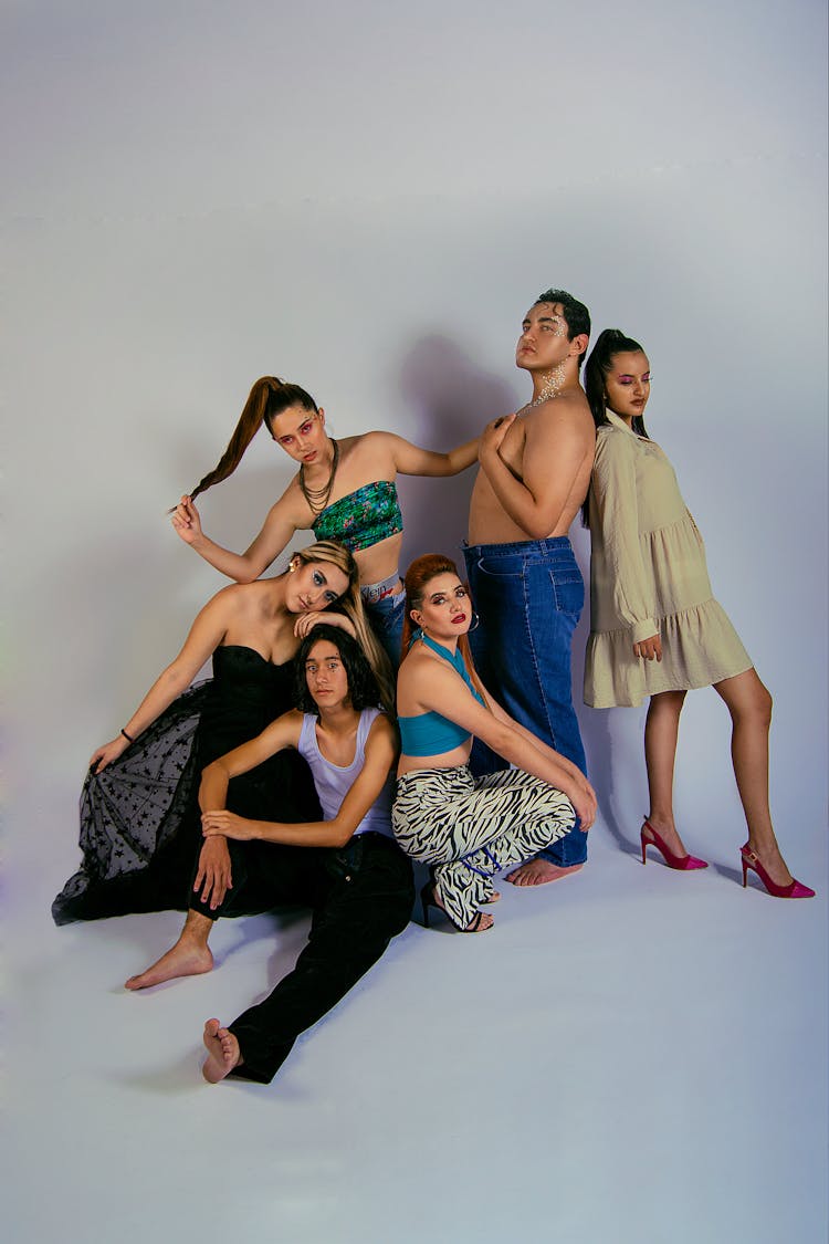 A Group Of People Posing On A White Background 