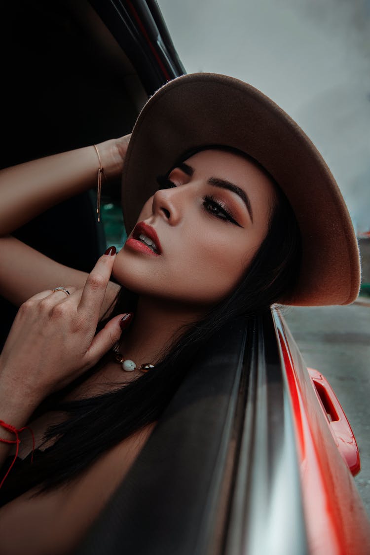 Woman In Hat Posing In Car Window