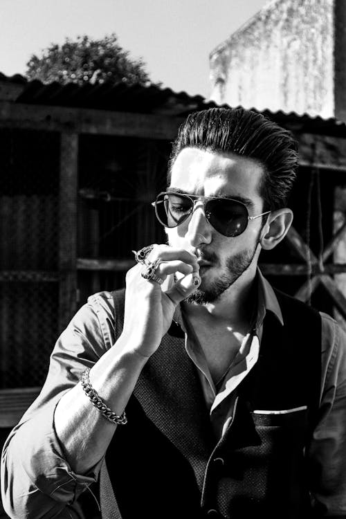 Grayscale Photo of a Man Smoking 