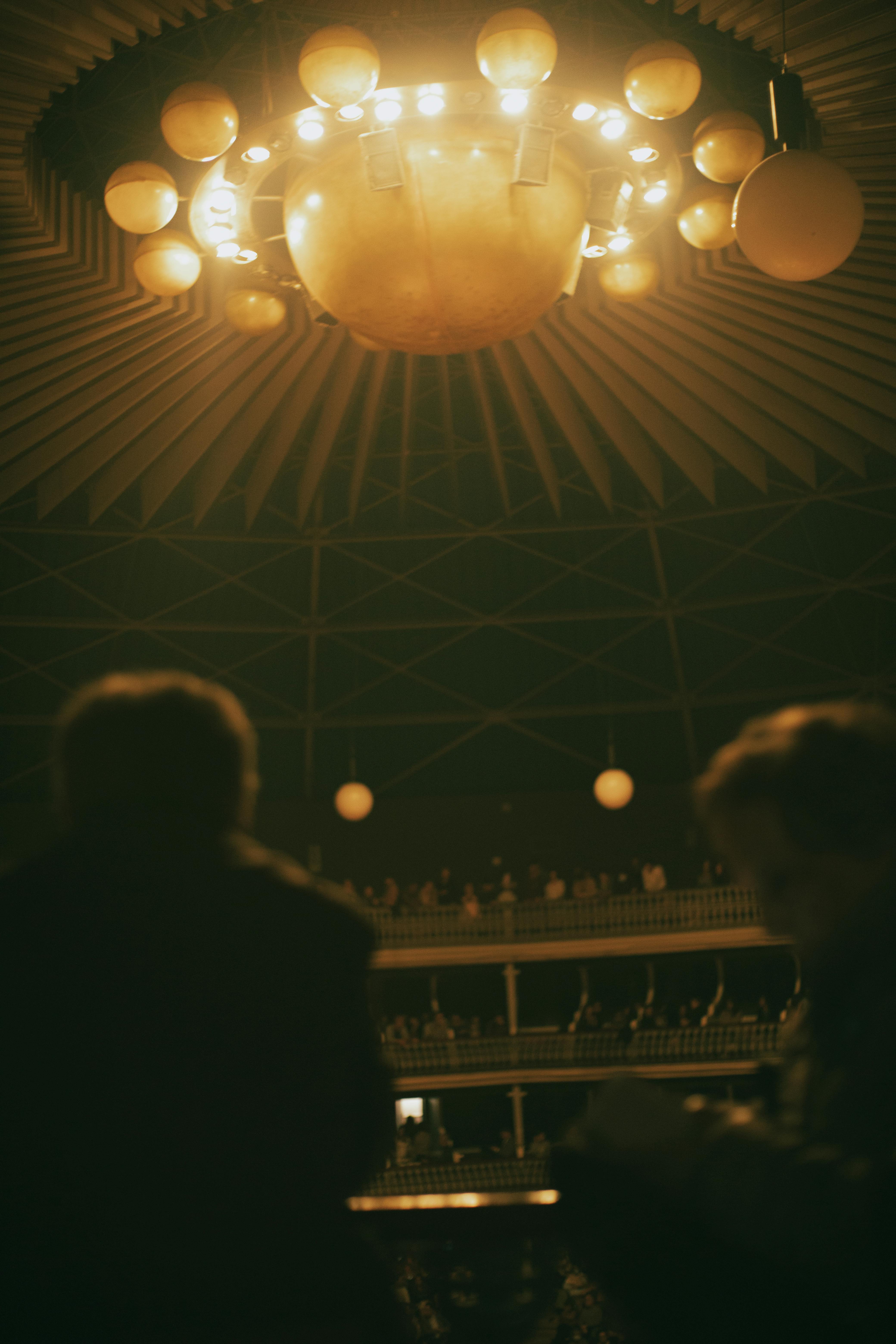 Free Majestic theater auditorium with a decorative chandelier and audience viewed from the stage. Stock Photo