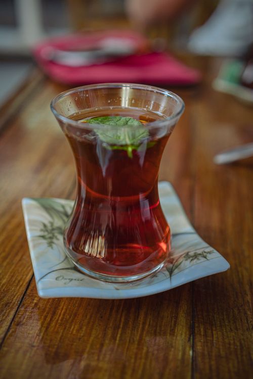 Free Close-up of traditional Turkish tea in glass with leaf on a wooden surface in Gaziantep, Turkey. Stock Photo
