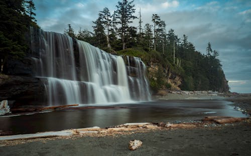 Photography Of Waterfalls Near Mountain