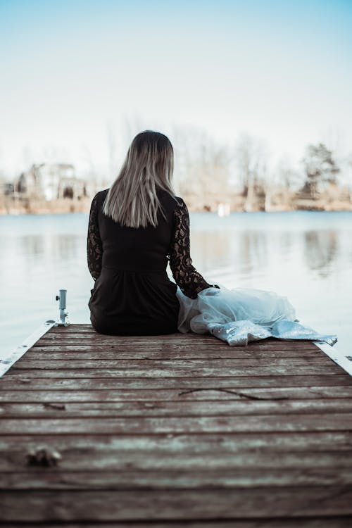 Woman Sitting on a Viewing Deck