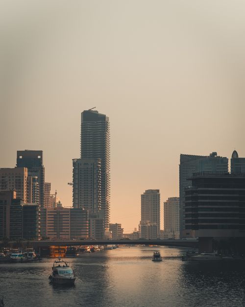 Free Dramatic sunset view of Dubai Marina's modern skyscrapers and canal waterways. Stock Photo