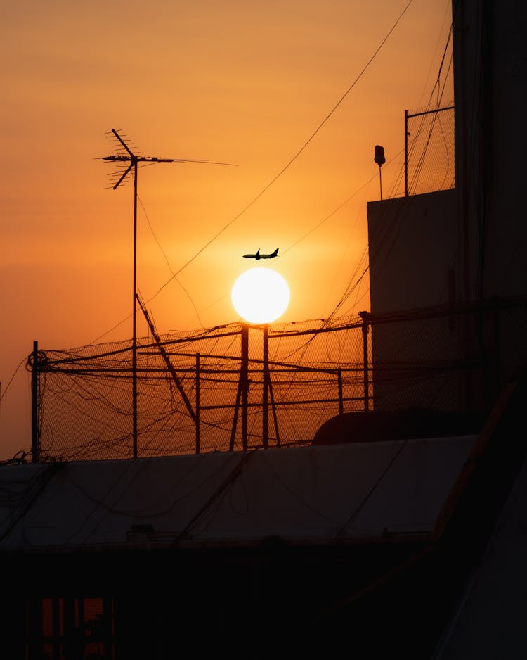 Airplane Over Setting Sun