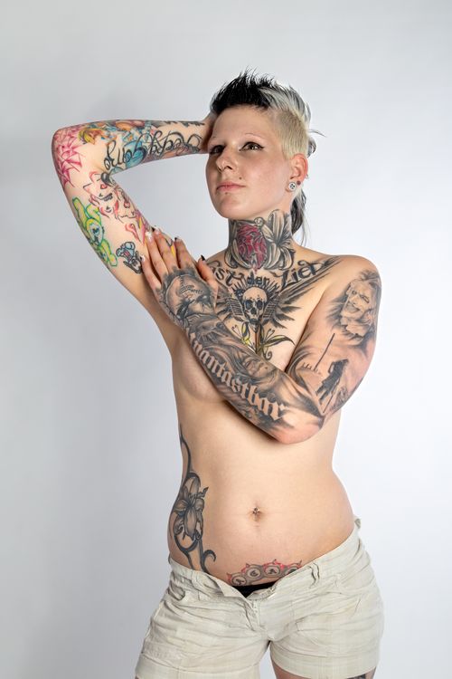 Free Striking studio portrait of a tattooed woman posing with confidence. Stock Photo