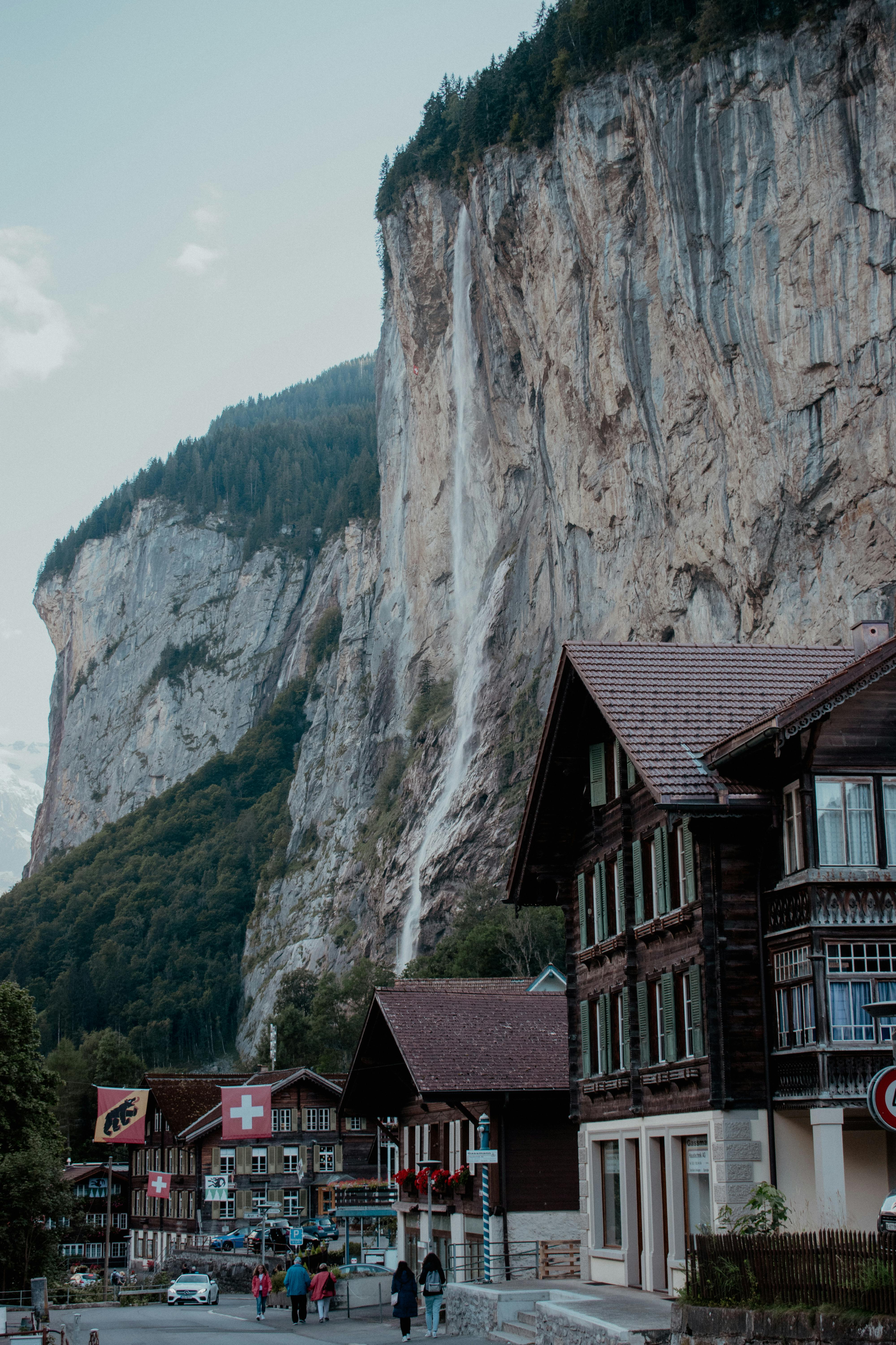 Picturesque view of Lauterbrunnen village with Staubbach Falls and traditional Swiss chalets.