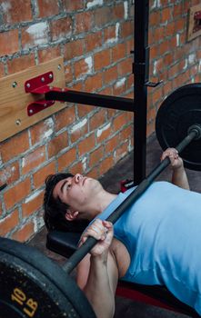 Man performing bench press exercise in a Mexico City gym, showcasing fitness and strength training.