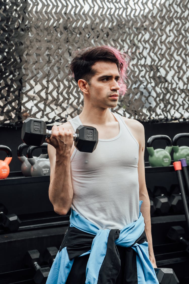 A Man Holding A Dumbbell