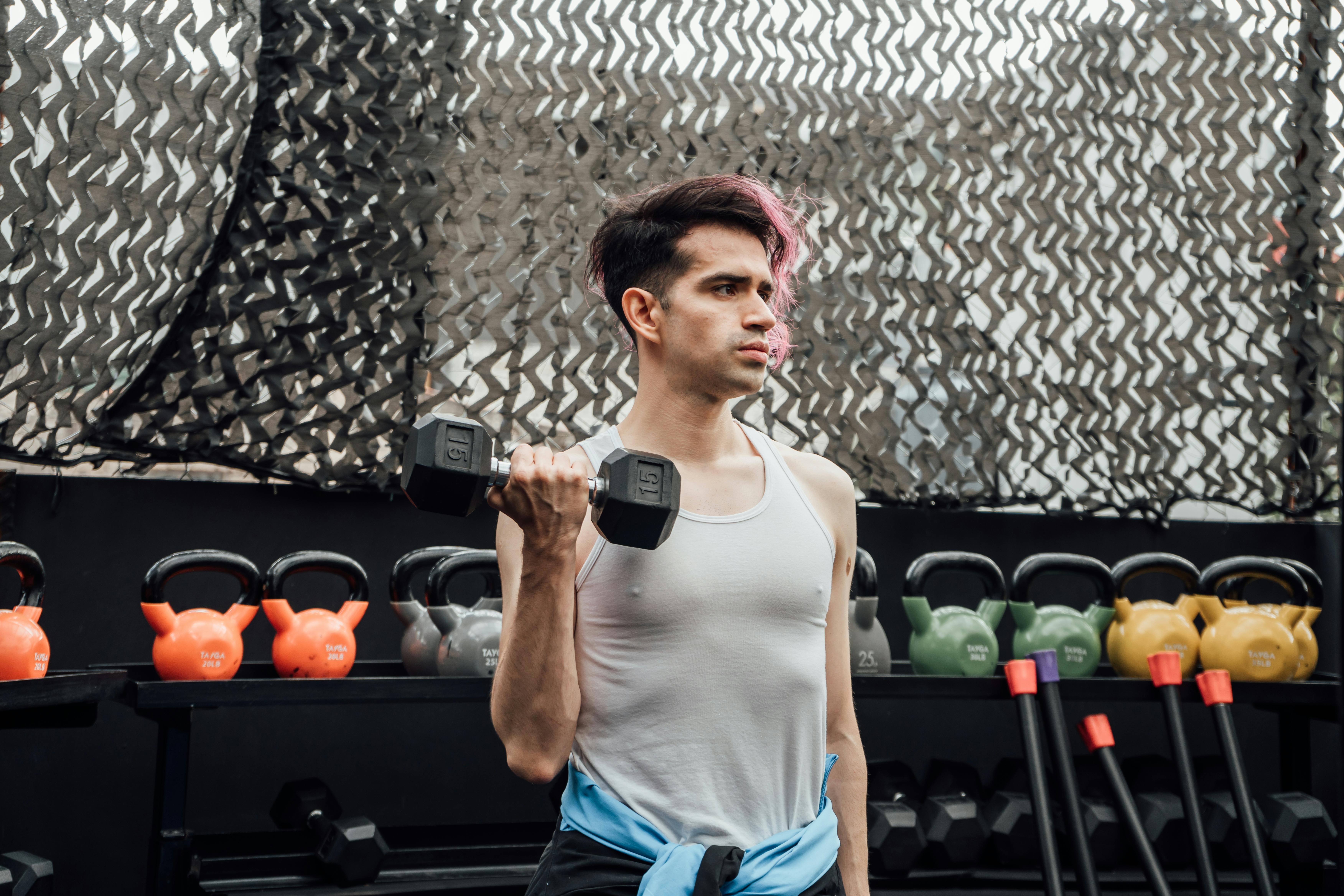 A Man Lifting Dumbbell while Wearing Virtual Goggles · Free Stock