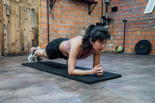 A woman doing a plank workout in a brick-walled gym, showcasing fitness and strength in Mexico City.