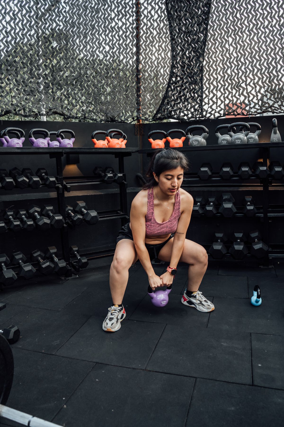 Female athlete lifting a kettlebell during strength training