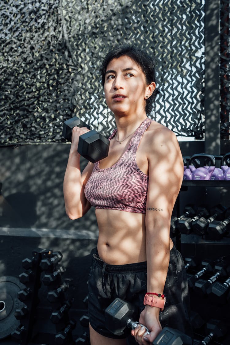 Woman Exercising With Dumbbells