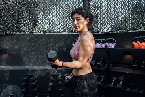 A Woman Lifting Dumbbells 