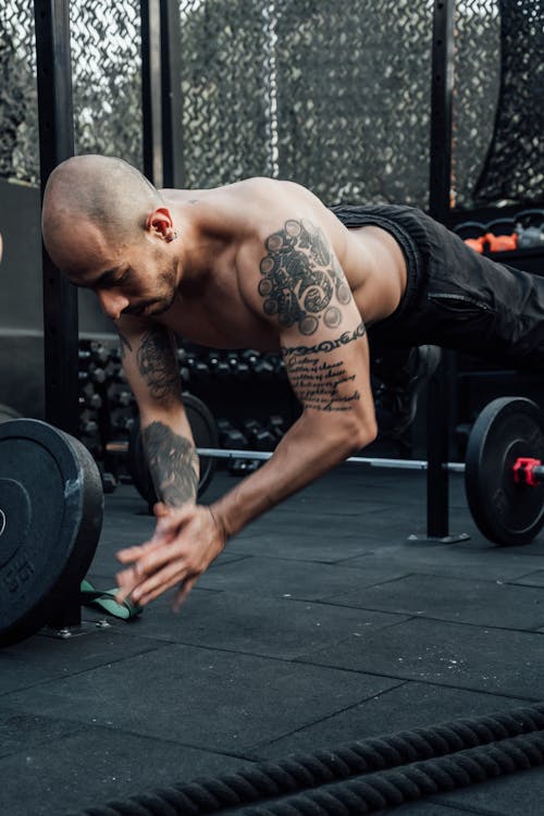 A Tattooed Man Working Out