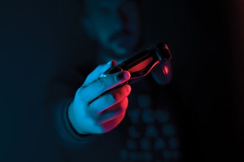 Close-up of Man Hand Holding Joystick in Dark