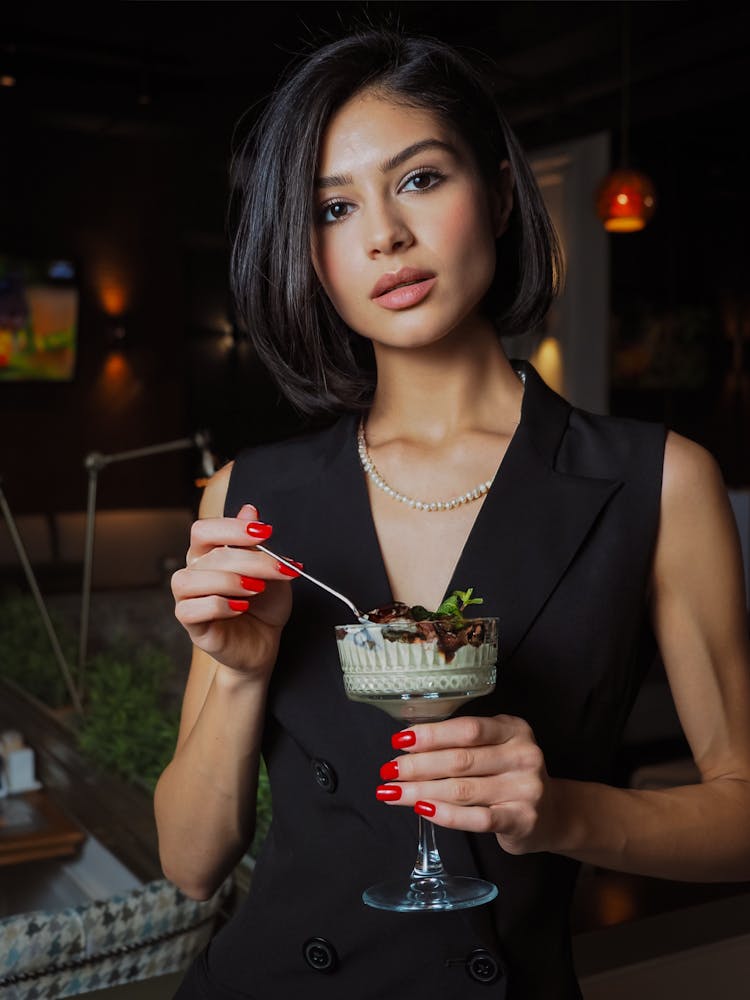 Woman Eating A Dessert With A Spoon