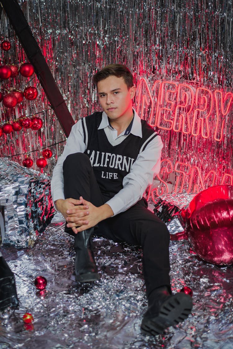 Man Sitting In Christmas Glitter Decorations