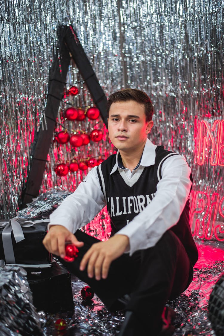 Man Posing In Glitter Christmas Decorations