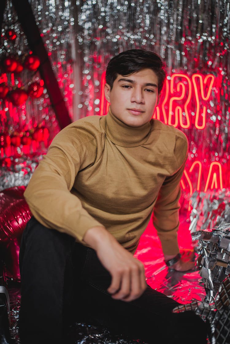 Young Man Posing In Glitter Decorations