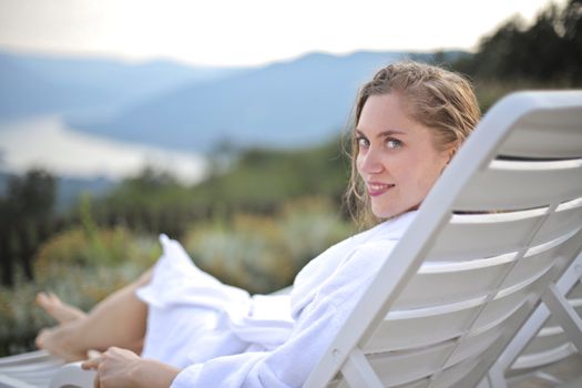 Woman enjoying leisure on a deck with scenic views in Visegrád, Hungary.