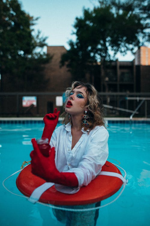 Beautiful Woman Wearing Shirt and Makeup in Swimming Pool