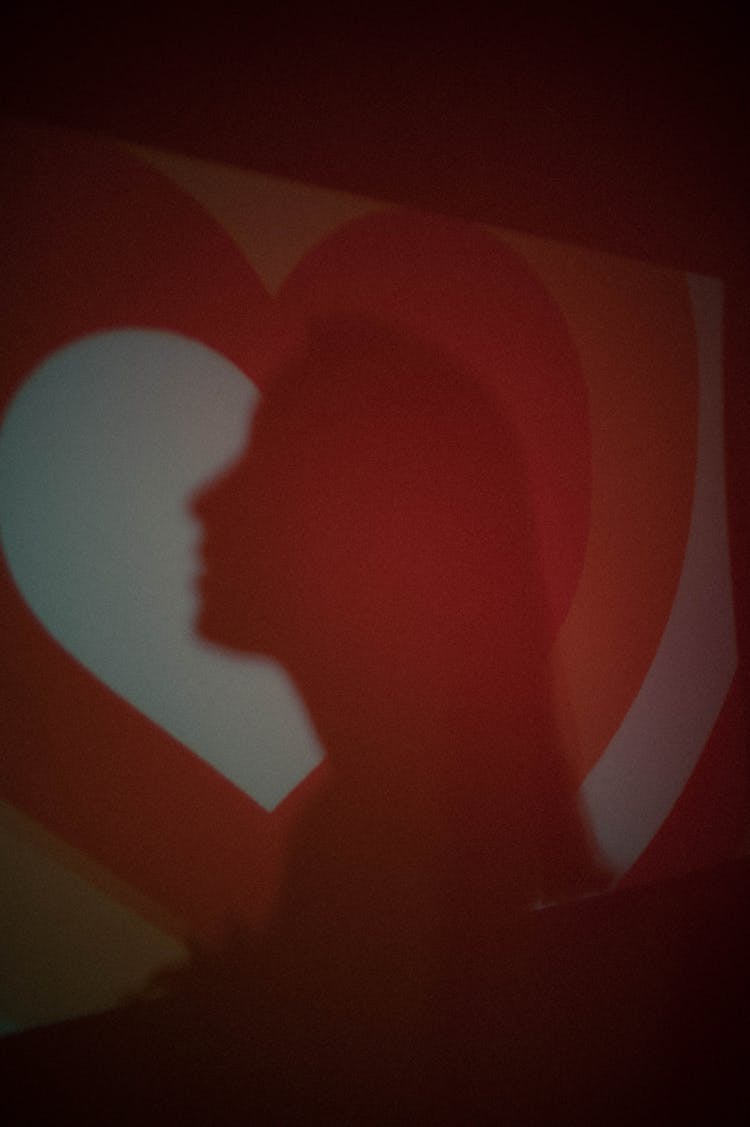 Shadow Of Woman On Wall Background With Heart