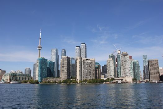 A stunning view of Toronto's skyline with the CN Tower on a clear day over the waterfront.