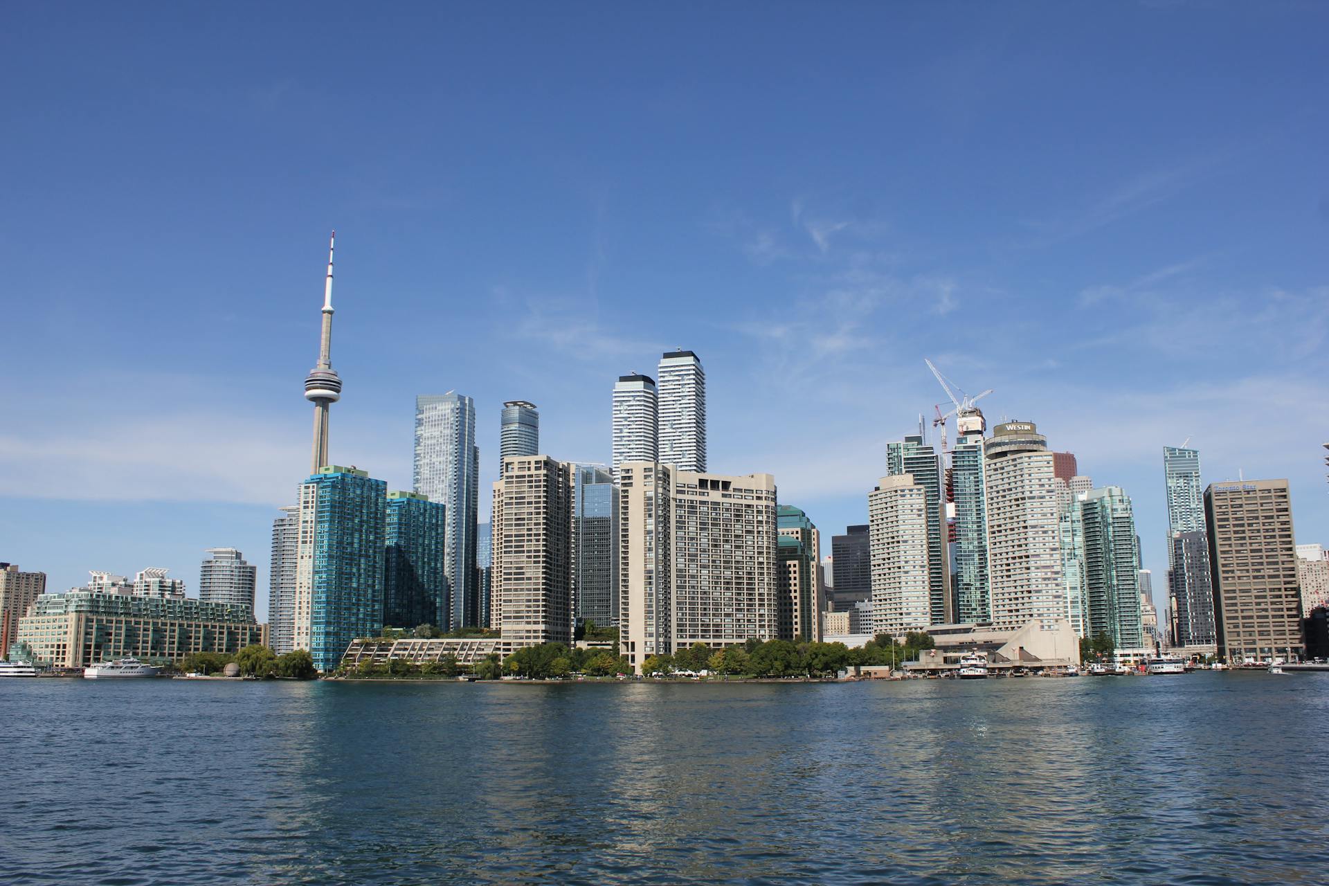 A stunning view of Toronto's skyline with the CN Tower on a clear day over the waterfront.