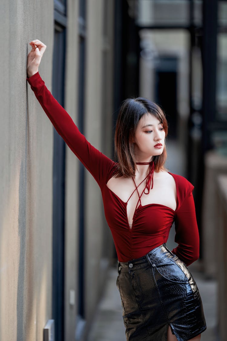 Asian Woman Leaning On Wall