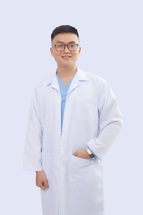 Man in White Lab Gown Wearing Eyeglasses