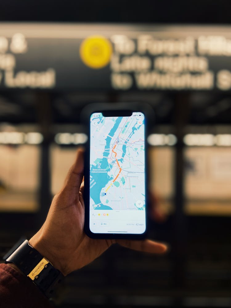 Person Holding A Phone With Map On The Screen 