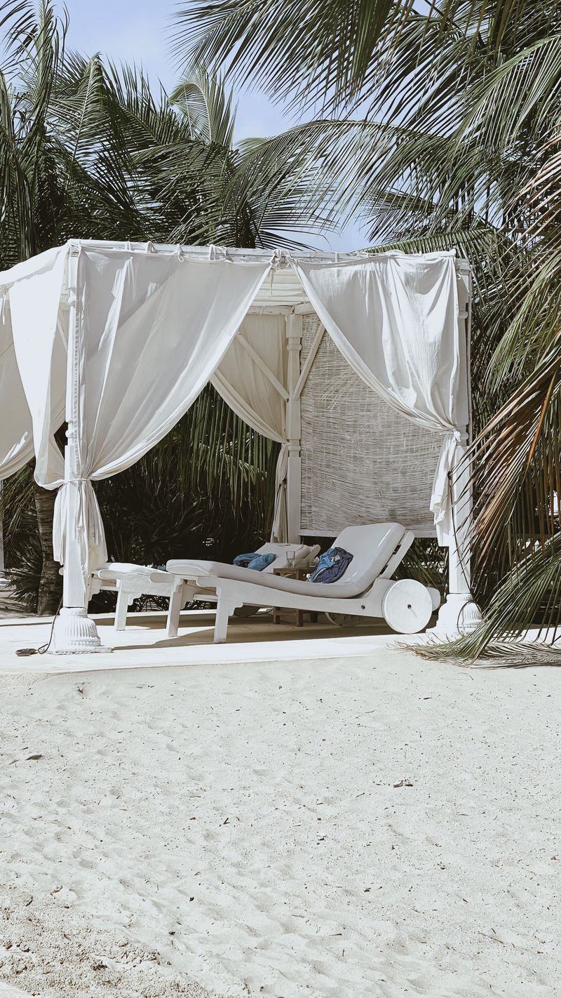 Private VIP cabana with day beds facing the lagoon